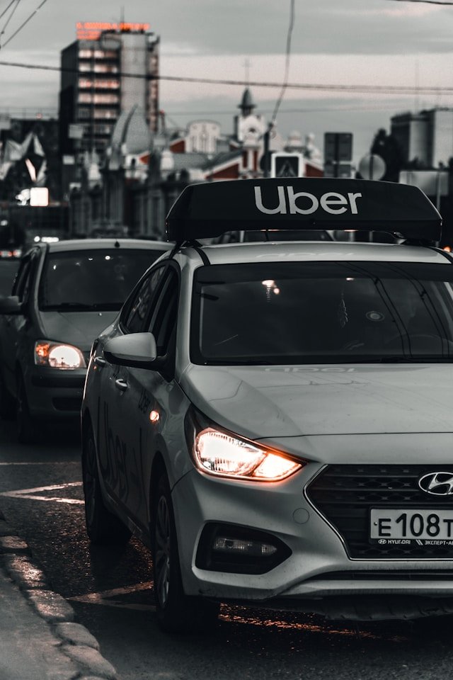 Compact 4 seater taxi parked in an urban setting.